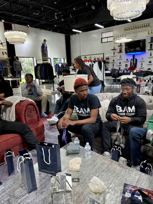 A gallery capturing the Becoming a Man (BAM) Youth Guidance attendees participating in the Dress for Success initiative. — photo 2