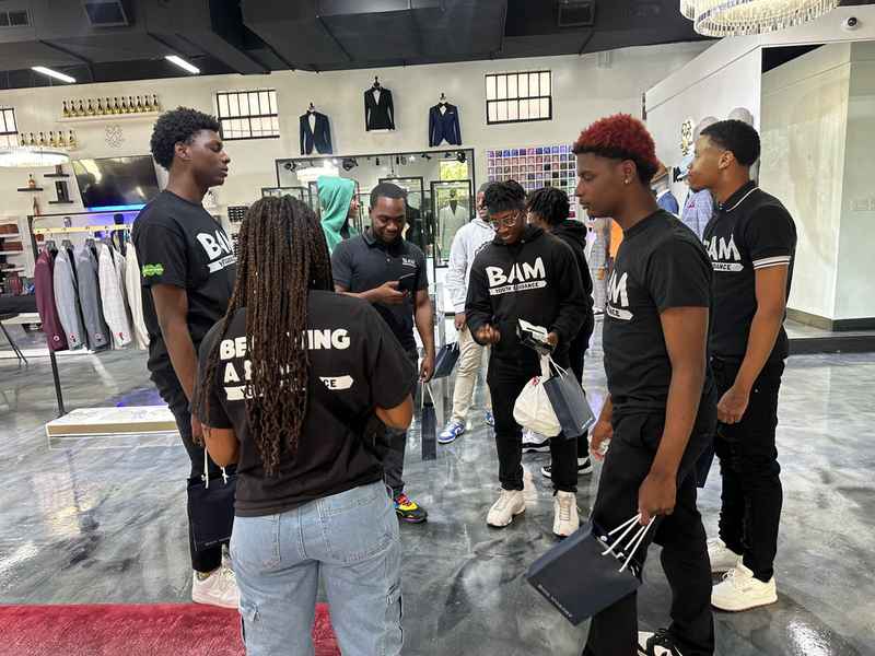 A gallery capturing the Becoming a Man (BAM) Youth Guidance attendees participating in the Dress for Success initiative. — photo 4