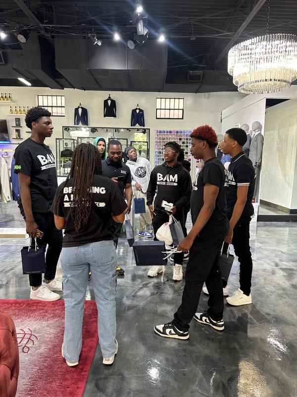 A gallery capturing the Becoming a Man (BAM) Youth Guidance attendees participating in the Dress for Success initiative. — photo 5