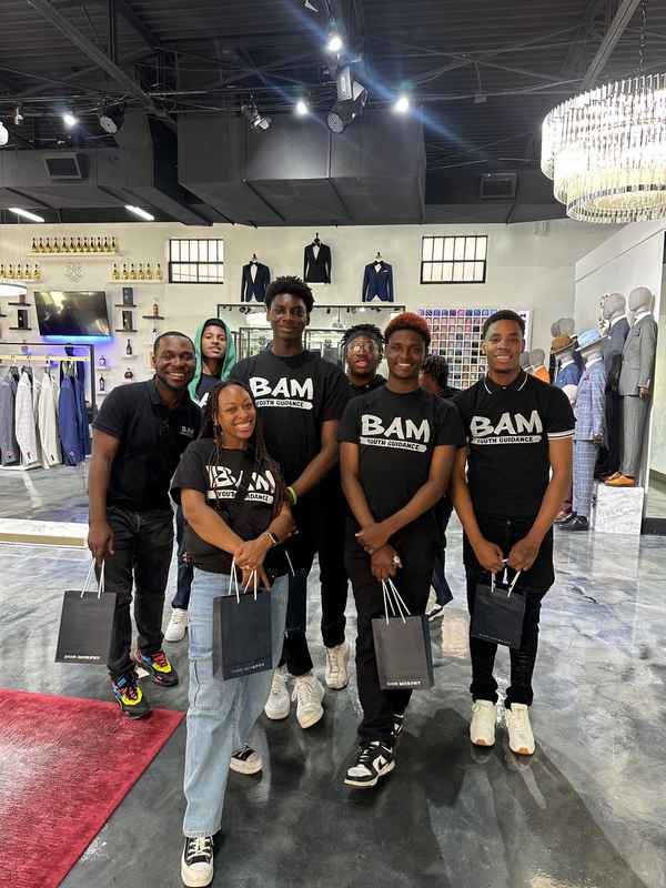 A gallery capturing the Becoming a Man (BAM) Youth Guidance attendees participating in the Dress for Success initiative. — photo 6