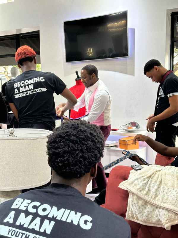 A gallery highlighting the Becoming a Man (BAM) Youth Guidance participants in the Dress for Success initiative, building confidence and career readiness. — photo 5