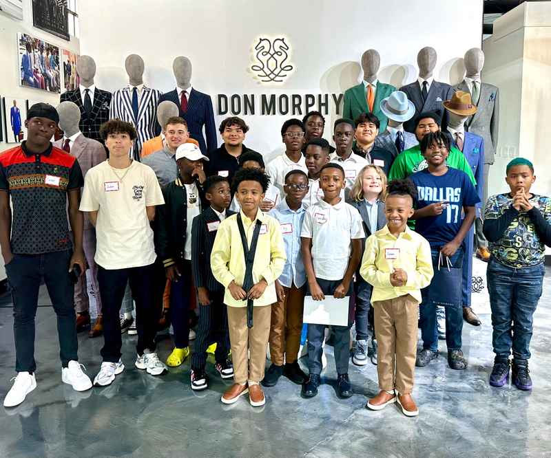 Group photo of workshop participants in front of the Don Morphy display