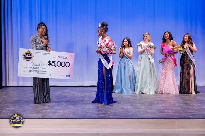 Miss Forney 2025 winner Aria Price is presented with a $5,000 scholarship check on stage alongside fellow contestants