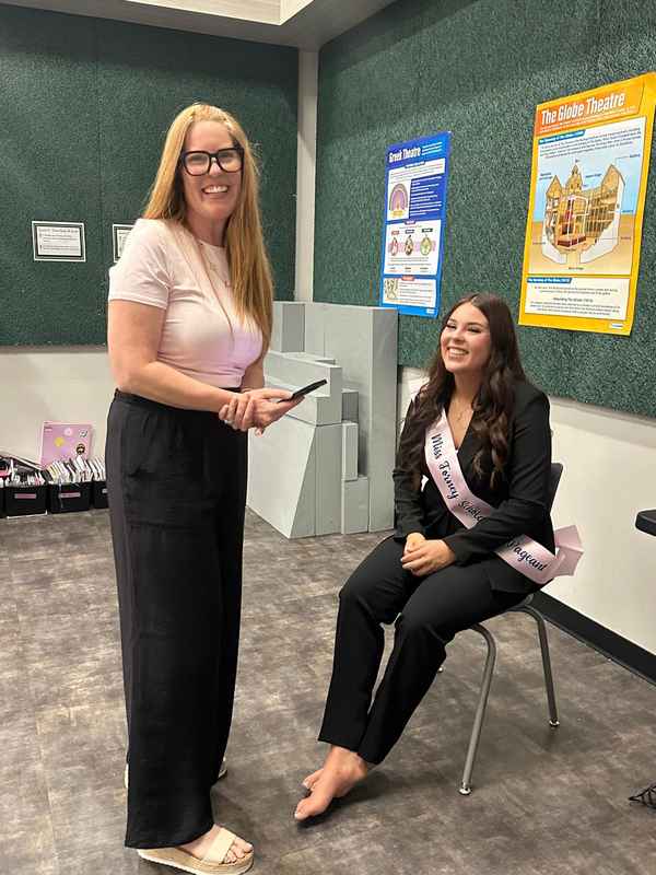 A sash-wearing Miss Forney Scholarship Pageant titleholder visiting a classroom