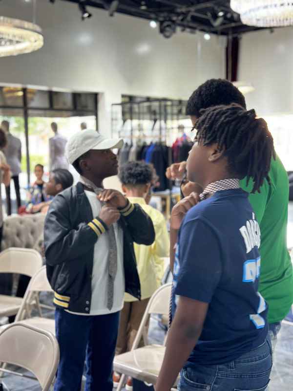 A gallery featuring participants engaging in the Dress for Success initiative, gaining professional attire and career preparation skills at the second monthly Dress-Up Discovery workshop. — photo 6